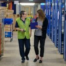 Two women in a work place, probably a storage facility