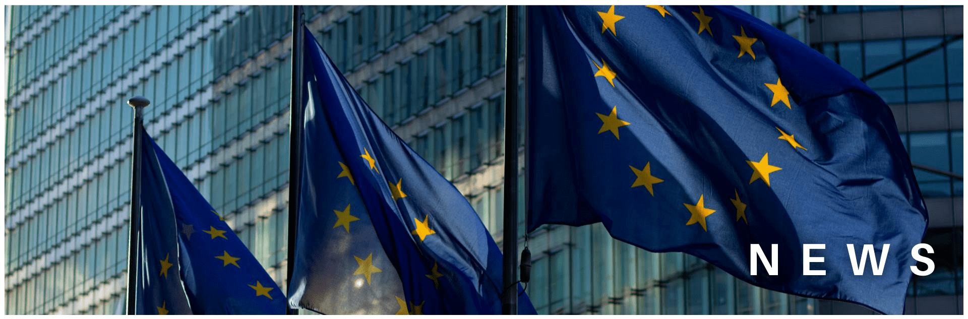 EU flags waving in front of a glass building in low sun. Copy reads: NEWS